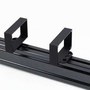 A black power brick bracket designed for a Samsung G5 monitor, mounted on a racing simulator rig.
